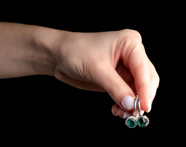 Applying clear nail polish to costume jewelry for protection