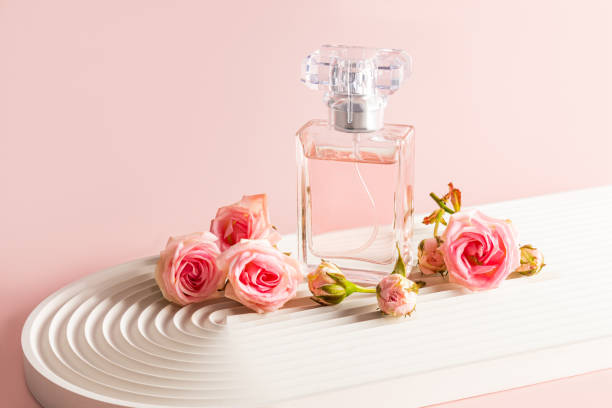 Timeless top 10 best-selling perfumes in the world - iconic perfume bottle amidst rose petals and greenery